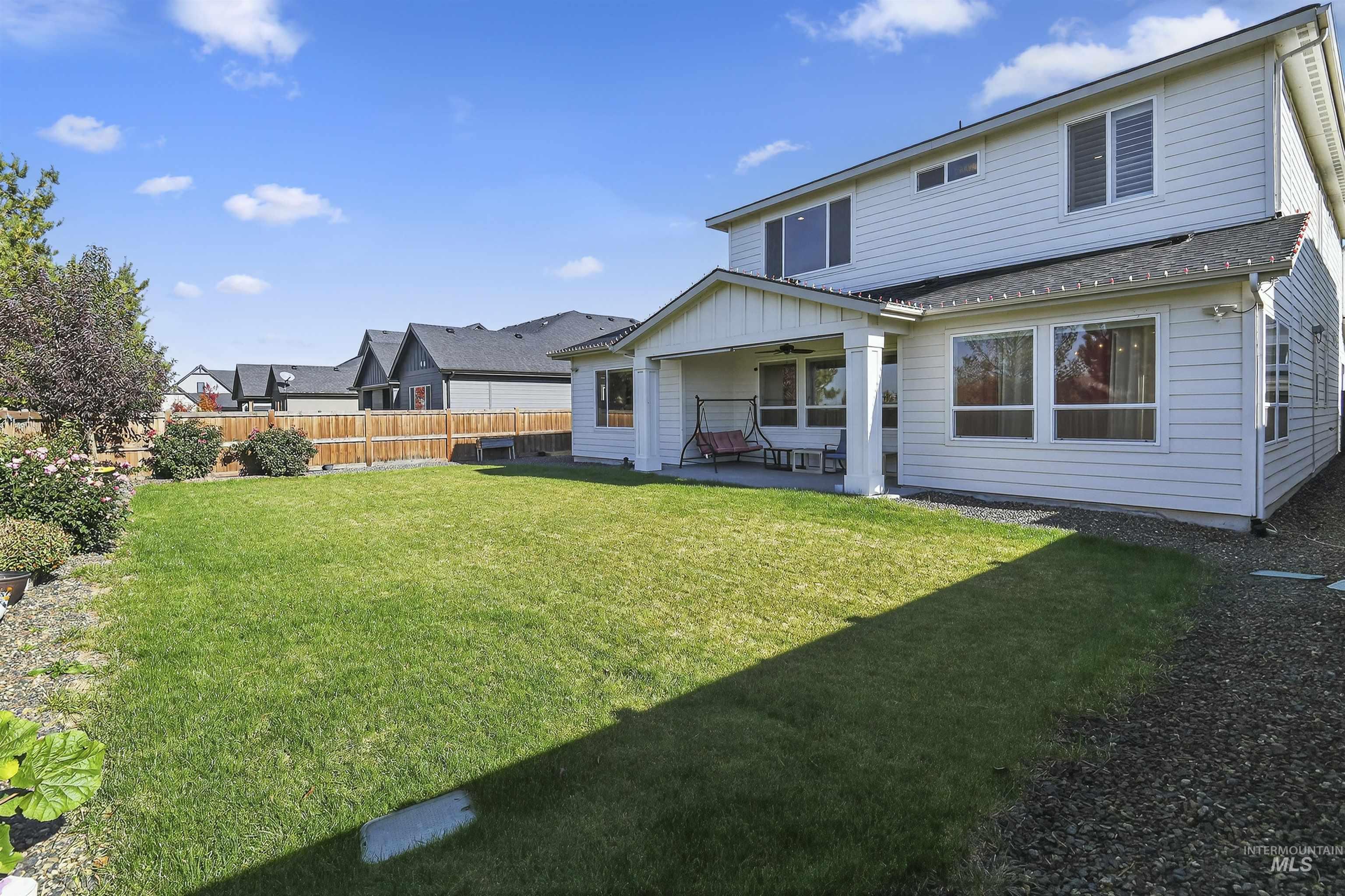 6839 North Willowside Avenue Meridian, ID 83646 - Photo 31 of 38 Rear view of house featuring a patio area, a fenced backyard, and roof with shingles