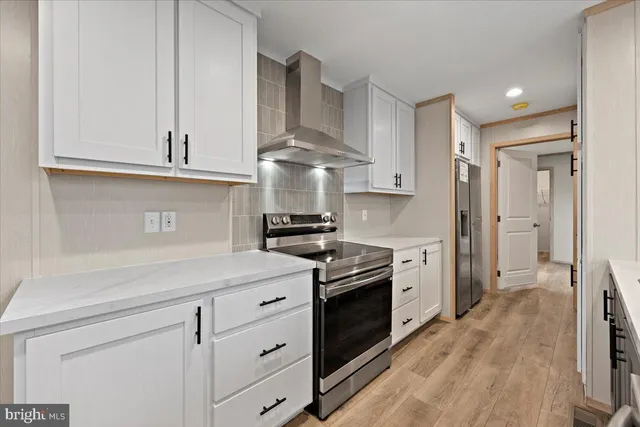 a kitchen with stainless steel appliances granite countertop a sink a stove and a refrigerator
