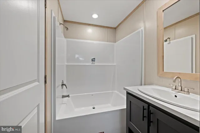 a bathroom with a bath tub sink mirror and a shower