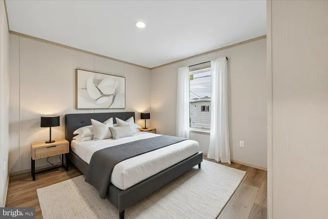 a bedroom with a bed and a night stand