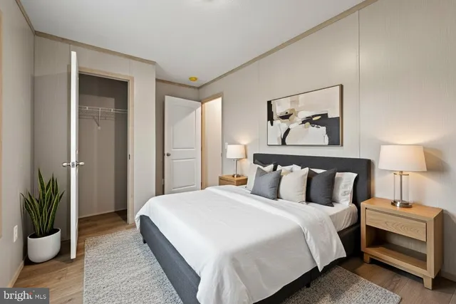 a bedroom with bed and a potted plant