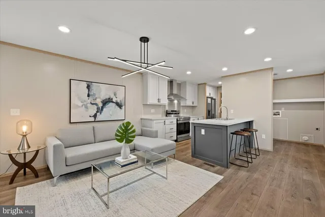 a living room with furniture and kitchen view