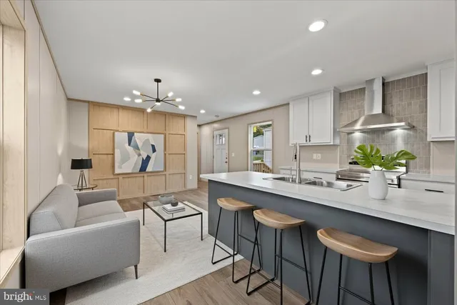 a very nice looking dining room with kitchen island a table and chairs in it