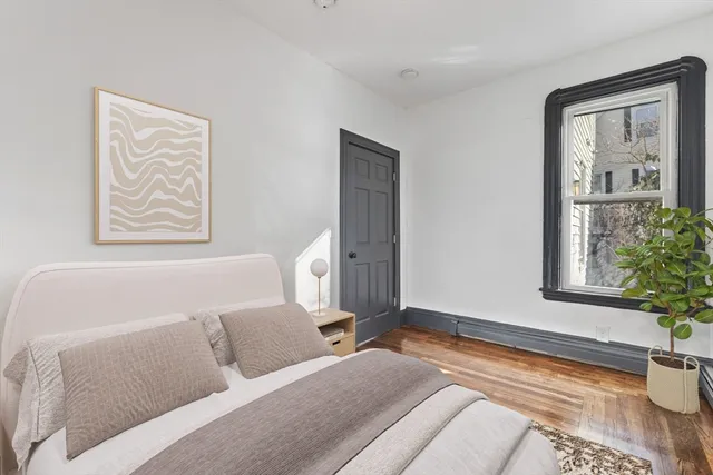 a bedroom with a bed and a window