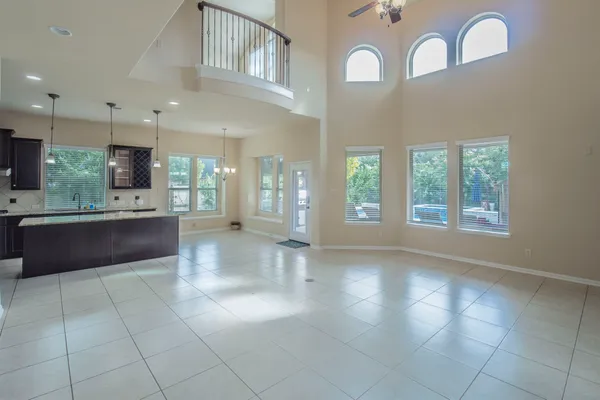 a large white kitchen with a large window