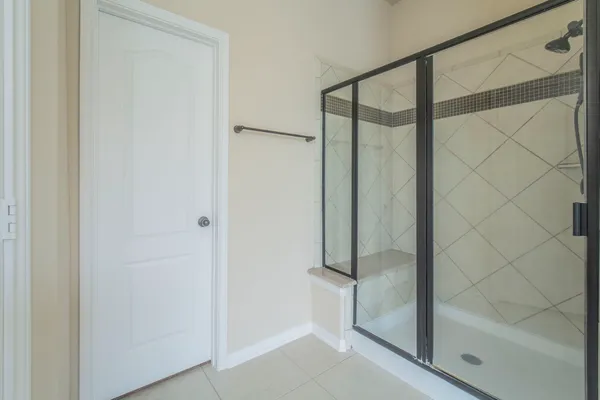 a bathroom with a glass shower door