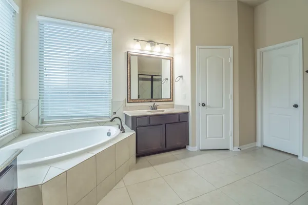a spacious bathroom with a bathtub and a sink