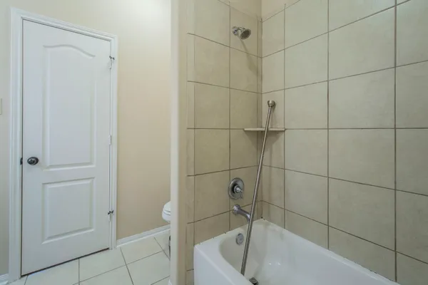 a bathroom with a tub and shower