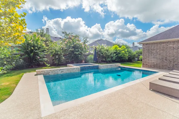 a view of a swimming pool with a yard