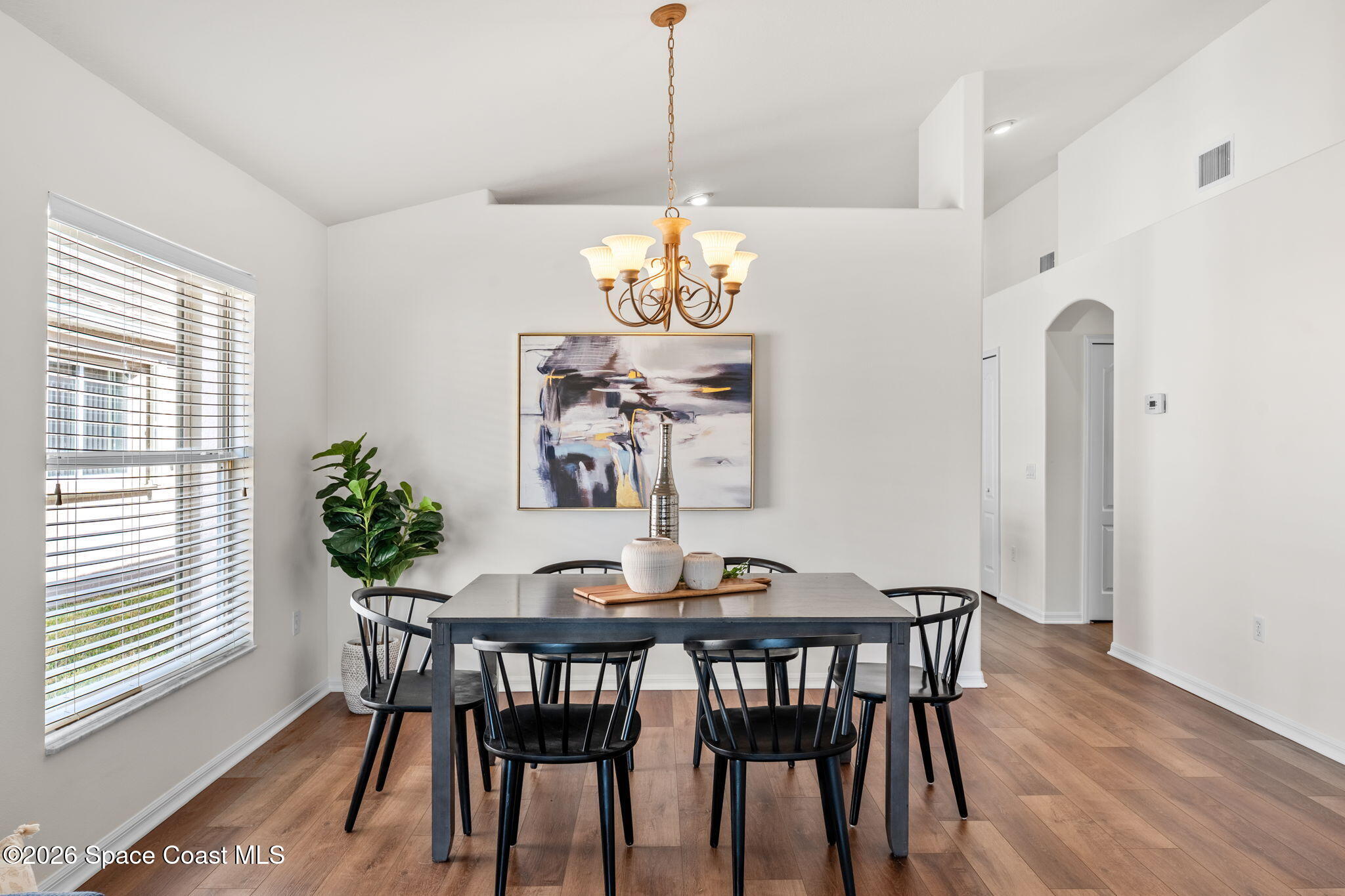 1634 Timacuan Drive Melbourne, FL 32940 - Photo 8 of 77 a dining room with furniture a chandelier and wooden floor