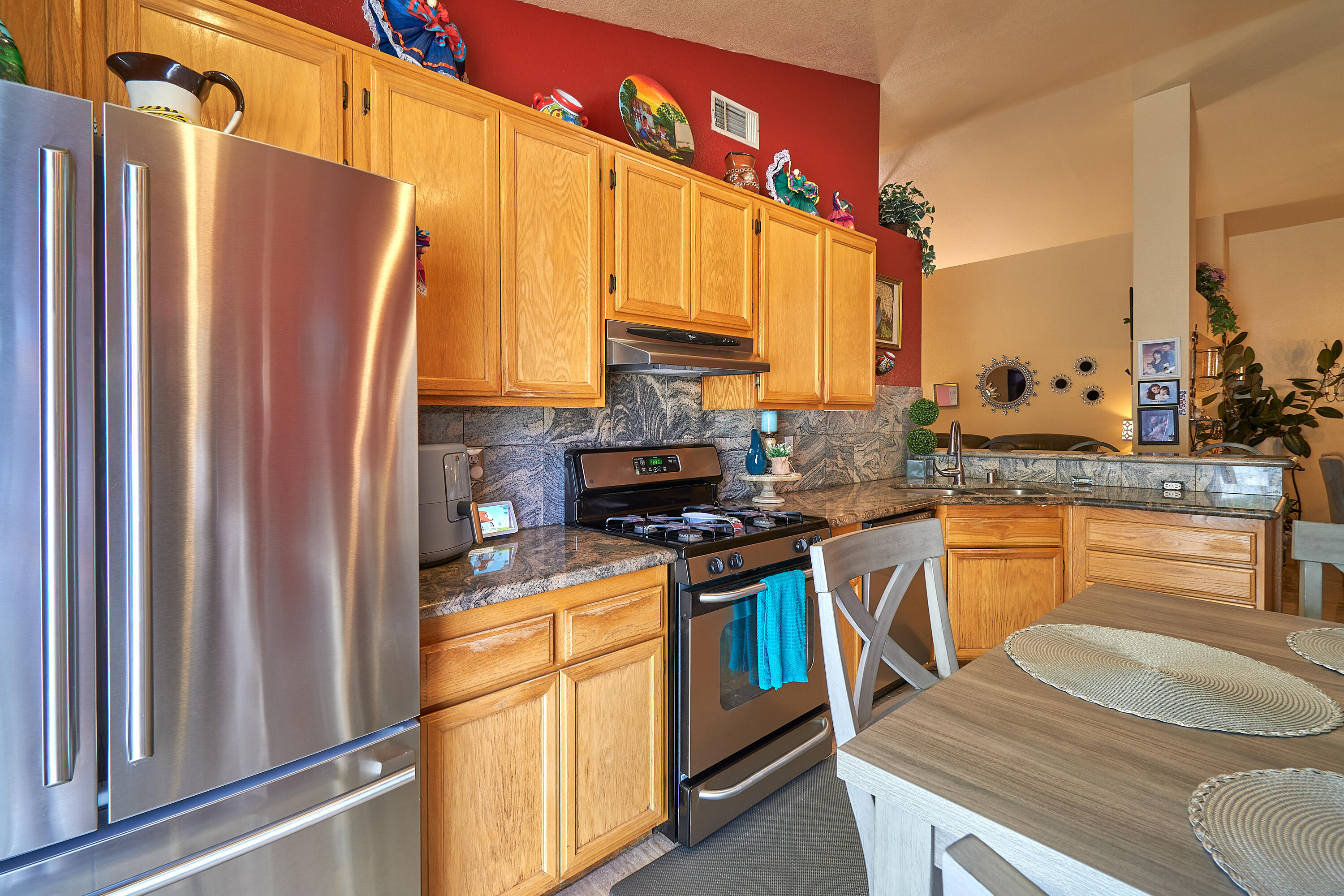44146 Cassia Drive Indio, CA 92201 - Photo 11 of 20 a kitchen with stainless steel appliances granite countertop a refrigerator a stove and a sink