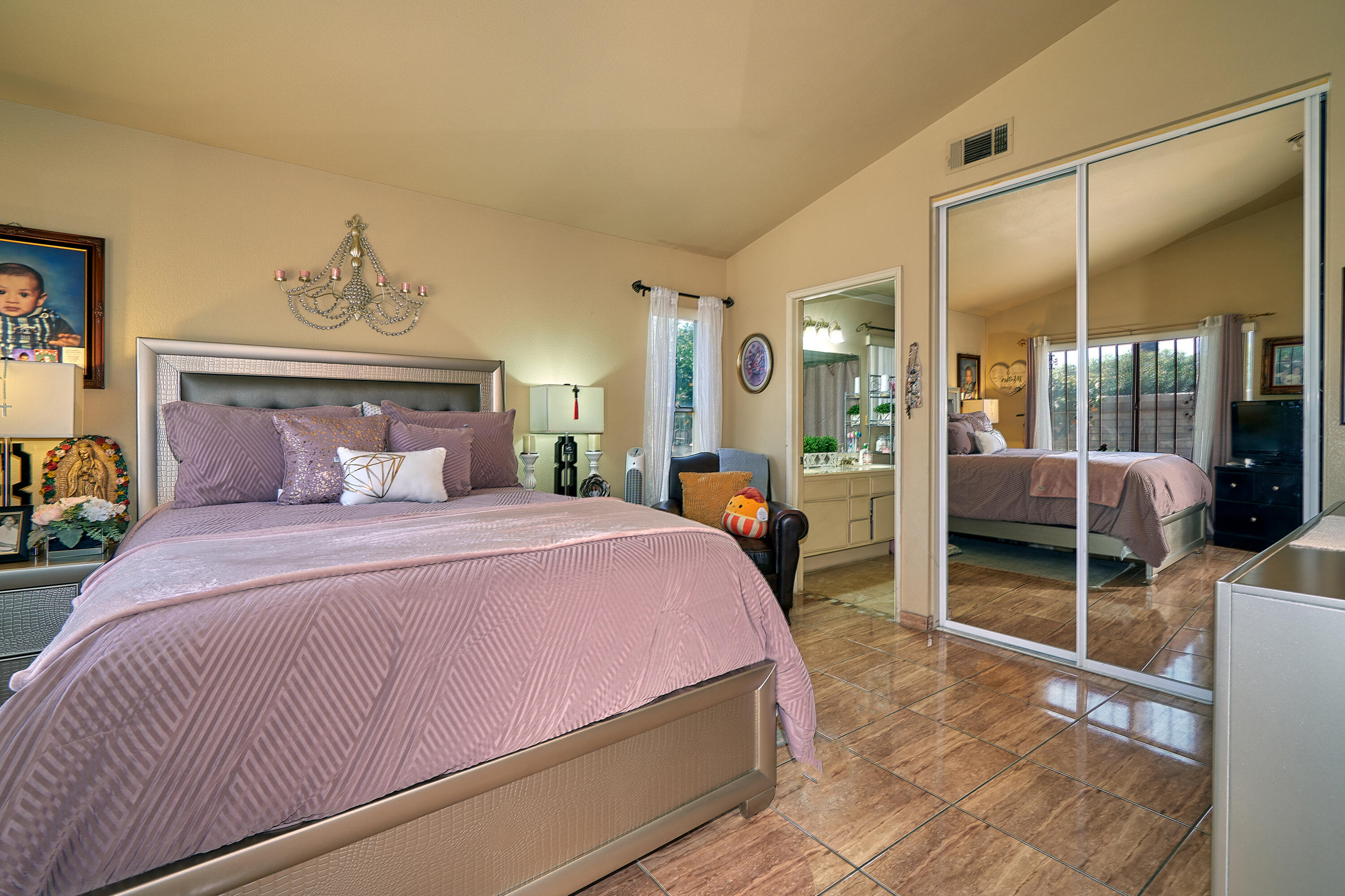 44146 Cassia Drive Indio, CA 92201 - Photo 14 of 20 a bedroom with a bed and a large mirror