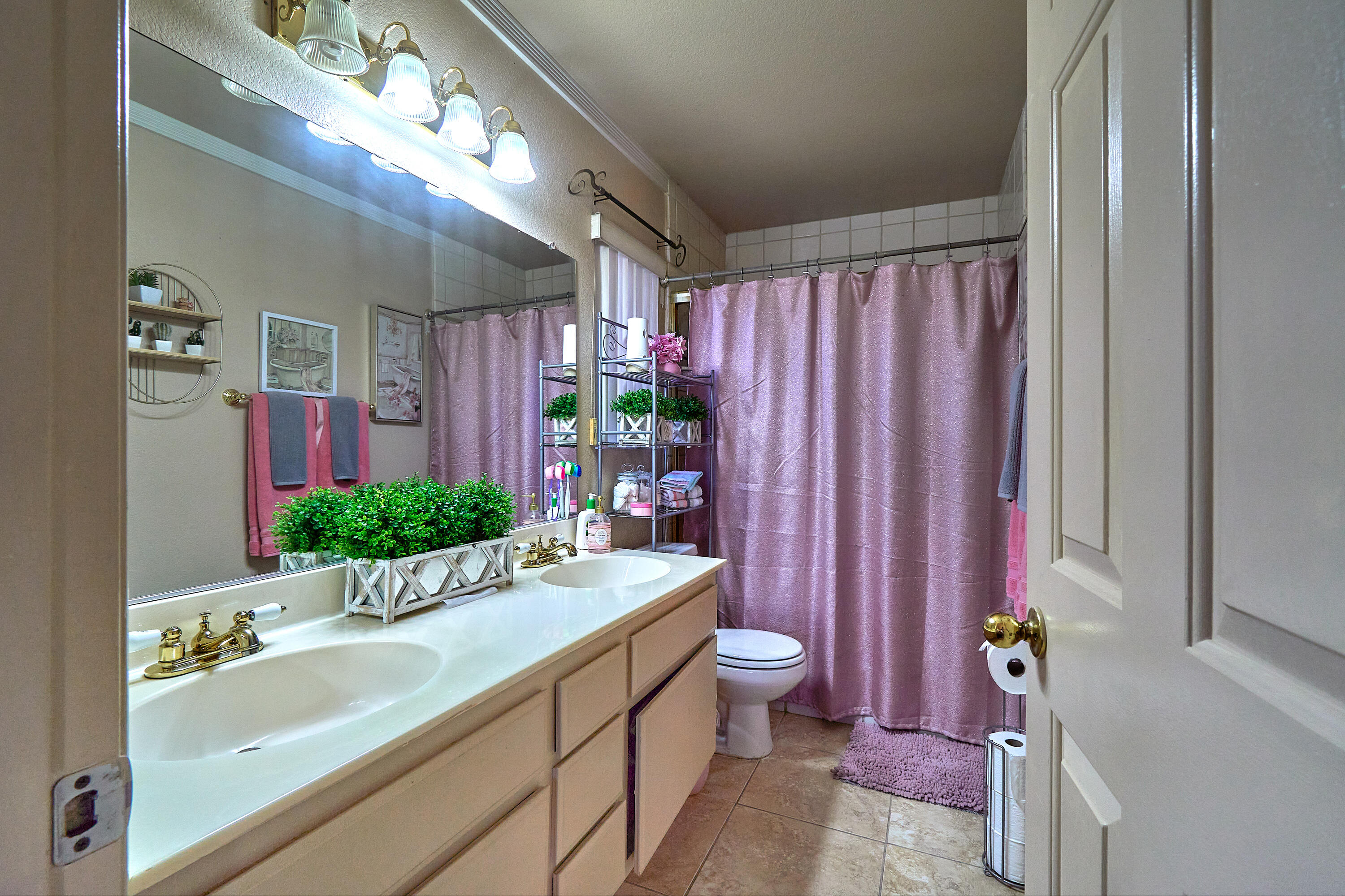 44146 Cassia Drive Indio, CA 92201 - Photo 15 of 20 a bathroom with a sink a large mirror and a shower