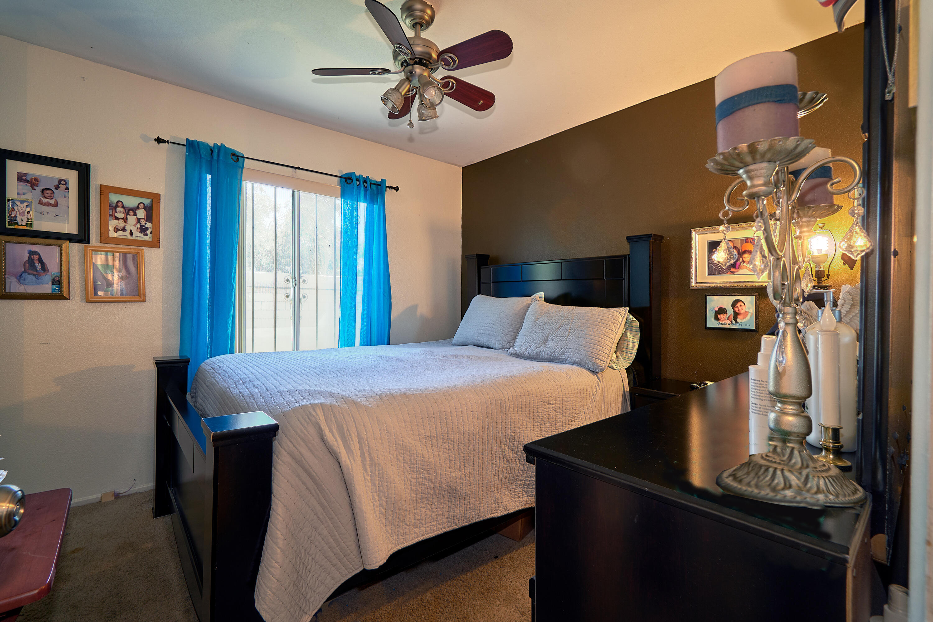 44146 Cassia Drive Indio, CA 92201 - Photo 16 of 20 a bedroom with a bed and a chandelier