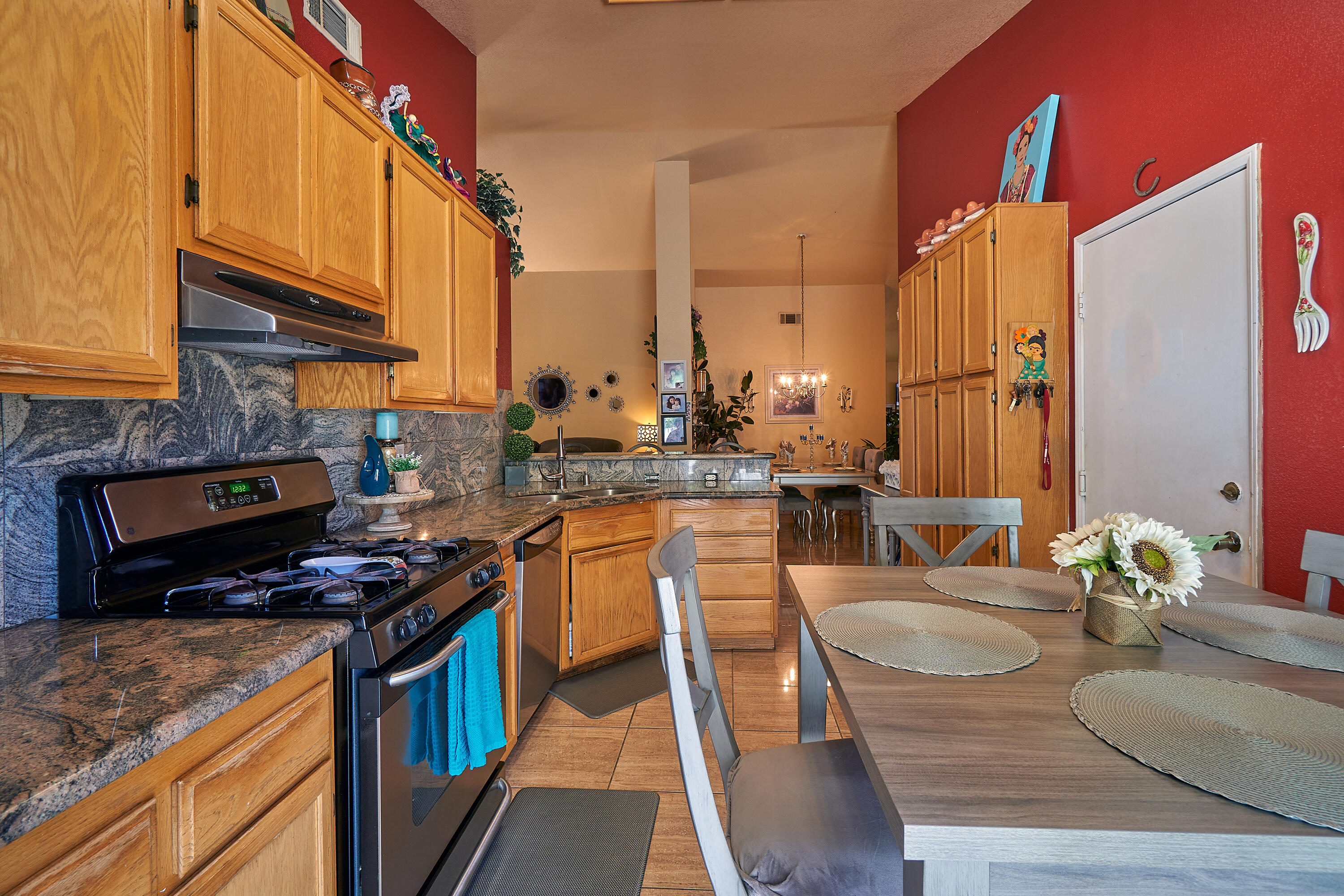 44146 Cassia Drive Indio, CA 92201 - Photo 10 of 20 a kitchen with stainless steel appliances granite countertop a stove a sink and a microwave