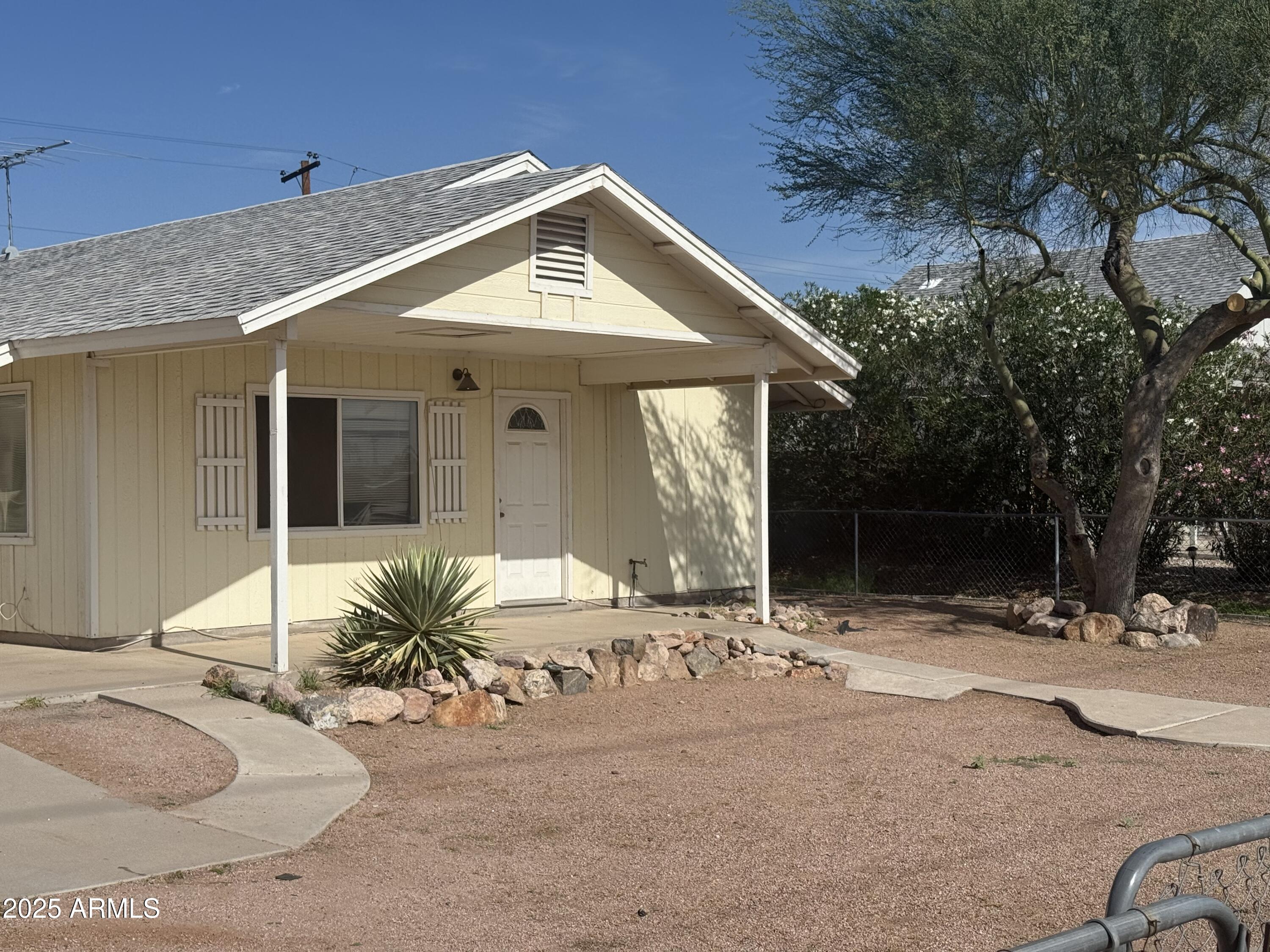 11020 East University Drive Apache Junction, AZ 85120 - Photo 3 of 9 a front view of a house with a yard