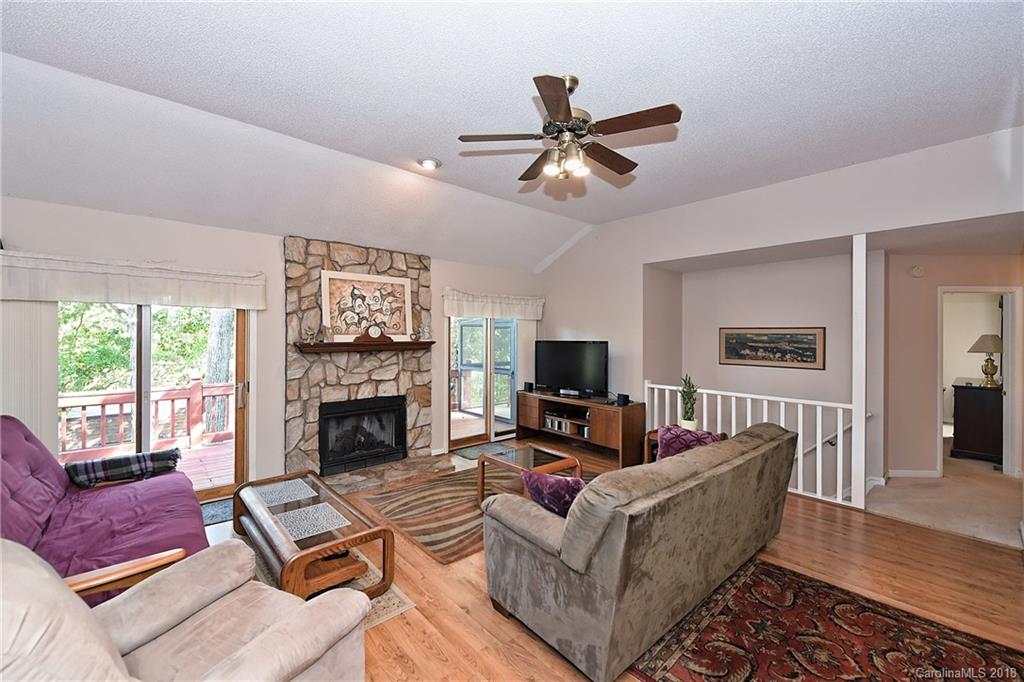 2003 Marquesas Avenue Tega Cay, SC 29708 - Photo 3 of 32 a living room with furniture a fireplace and a flat screen tv
