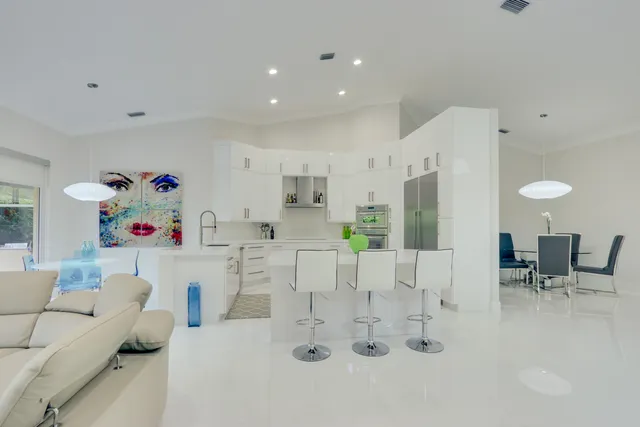 a kitchen with white cabinets and appliances