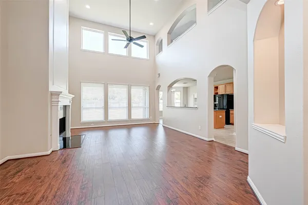 a view of a big room with wooden floor windows and cabinet