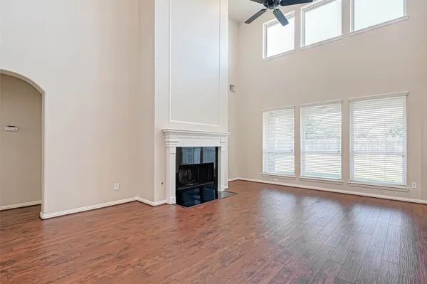 a kitchen with stainless steel appliances granite countertop a stove top oven a sink dishwasher and a refrigerator with wooden cabinets