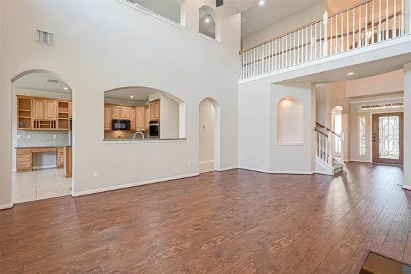 a kitchen with stainless steel appliances granite countertop a refrigerator a stove and a sink