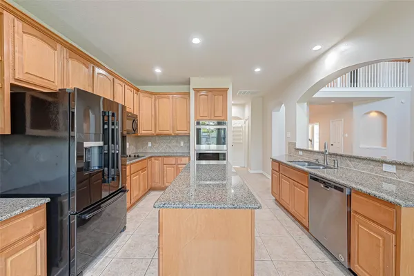 an empty room that has a window and a chandelier