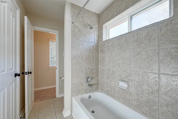 a view of room with a ceiling fan and a window