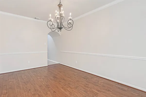 a view of a room with wooden floor closet and fan