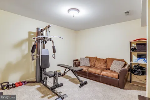 a room with gym equipment and view of living room
