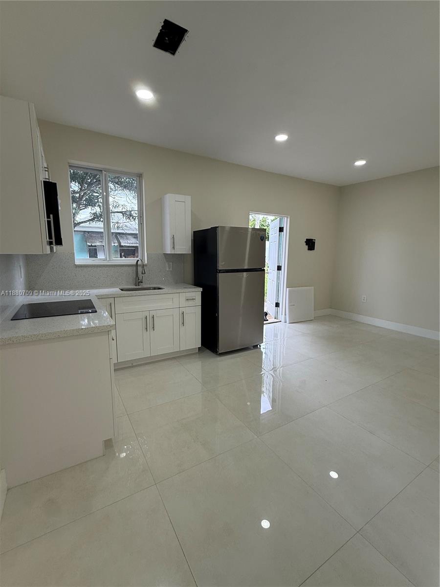 559 Northwest 2nd Street, Unit 2 Florida City, FL 33034 - Photo 2 of 8 a kitchen with a refrigerator and microwave