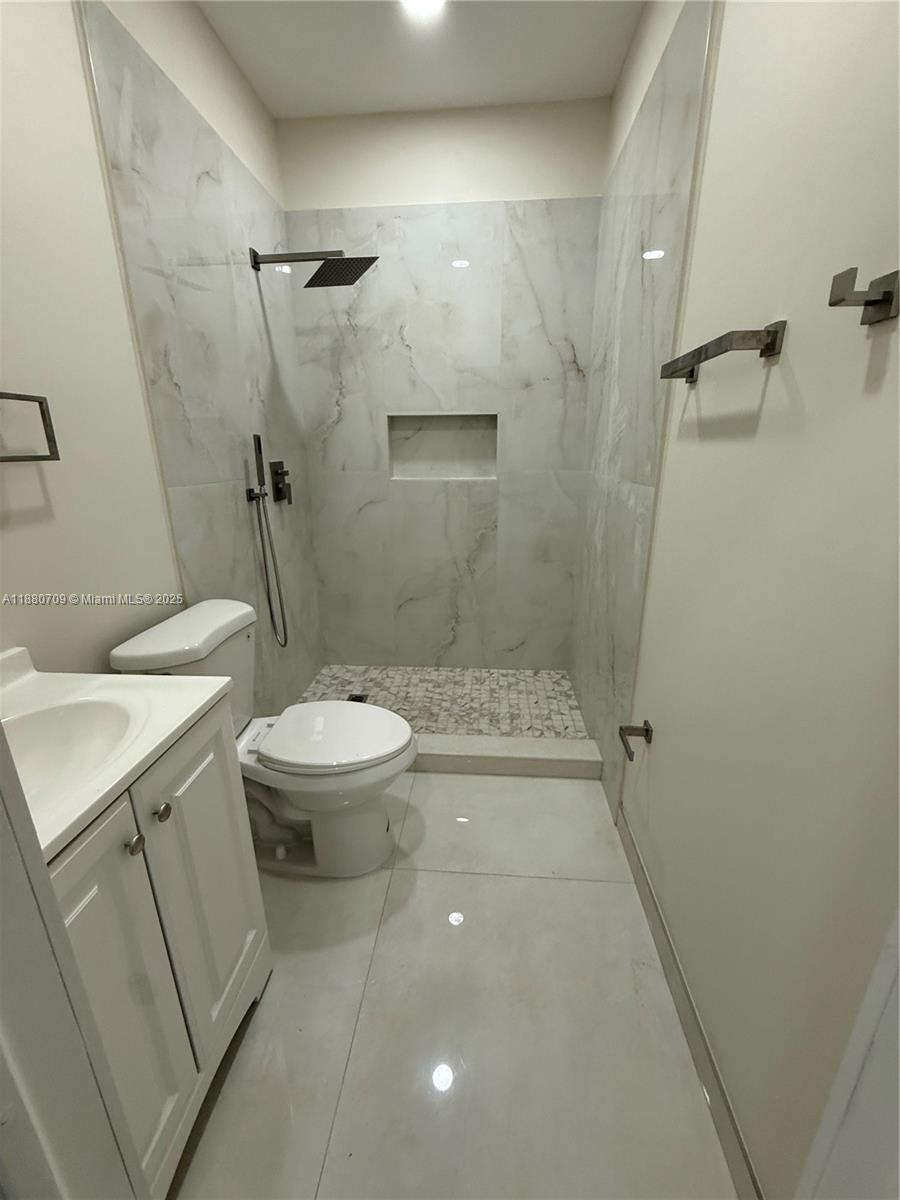 559 Northwest 2nd Street, Unit 2 Florida City, FL 33034 - Photo 6 of 8 a bathroom with a sink and toilet