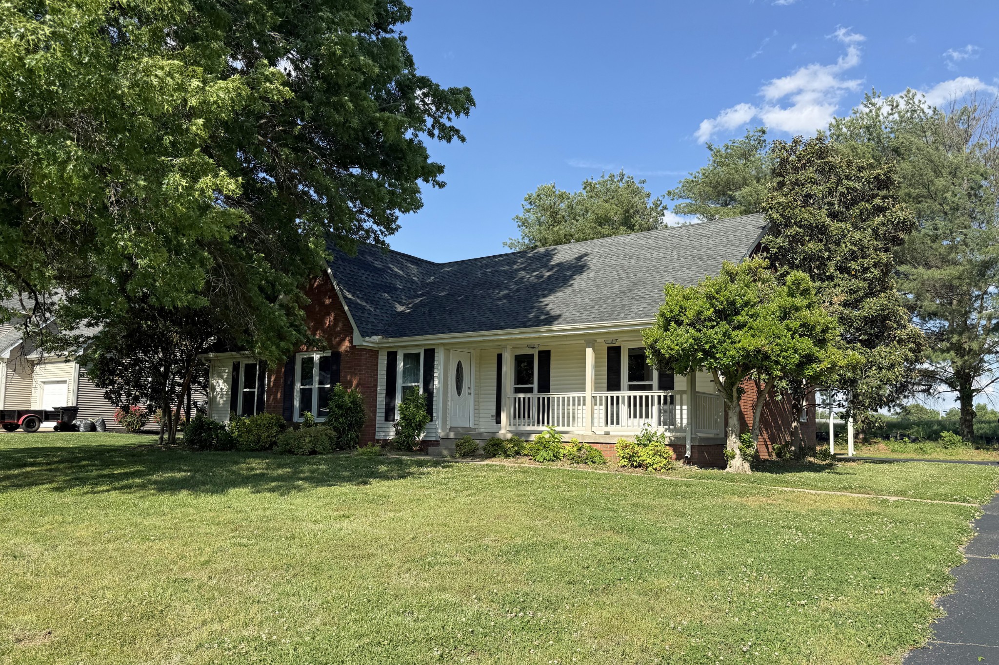 a front view of house with yard and green space