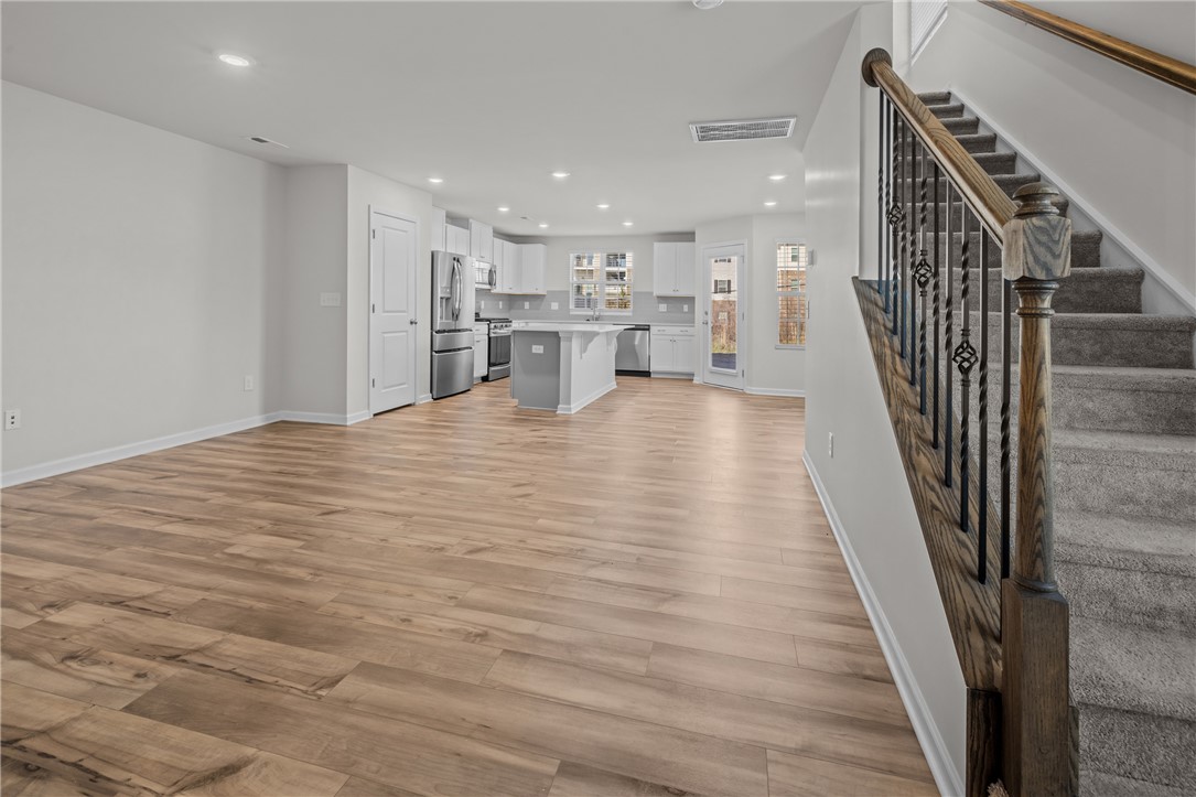 516 Brasstown Court Pendleton, SC 29670 - Photo 7 of 23 An inviting open-concept living area boasts a modern kitchen and convenient staircase access.