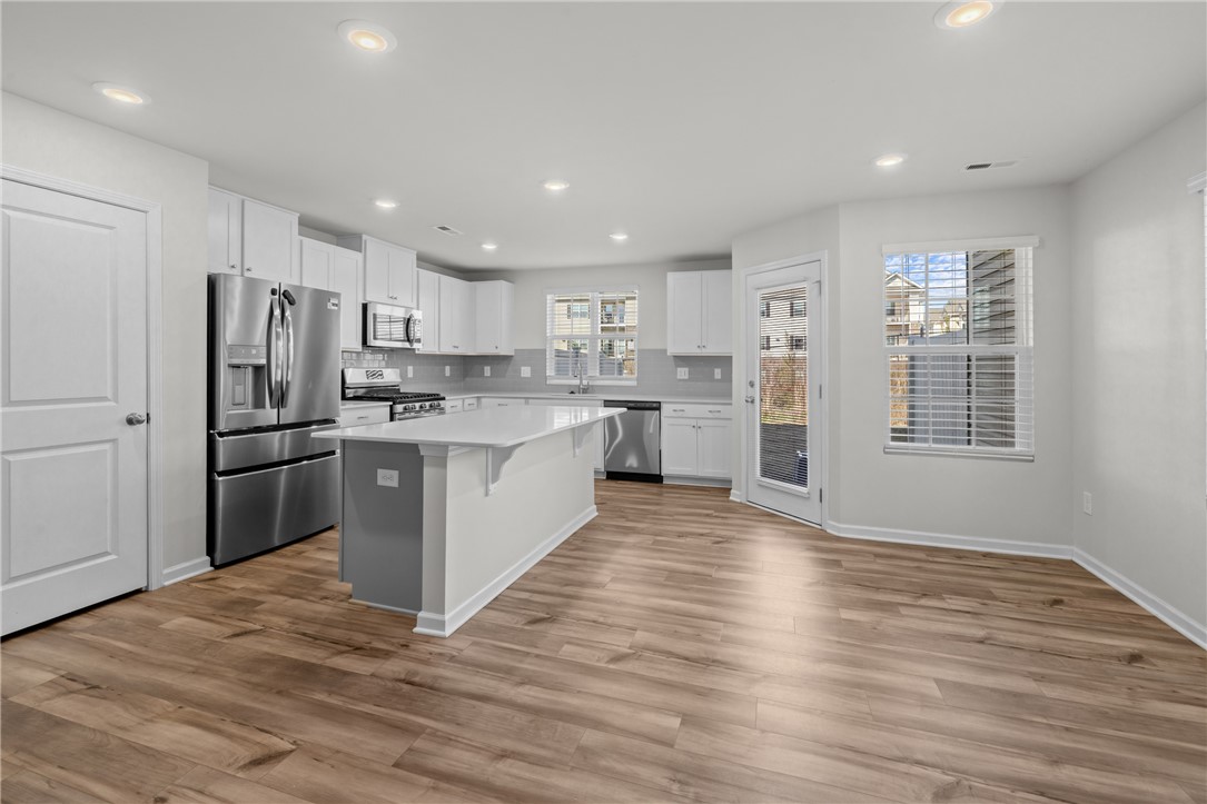516 Brasstown Court Pendleton, SC 29670 - Photo 10 of 22 This spacious kitchen offers abundant counter space, sleek appliances, and durable flooring, perfect for daily living. The island had room for seating as well as a dining area to the side.