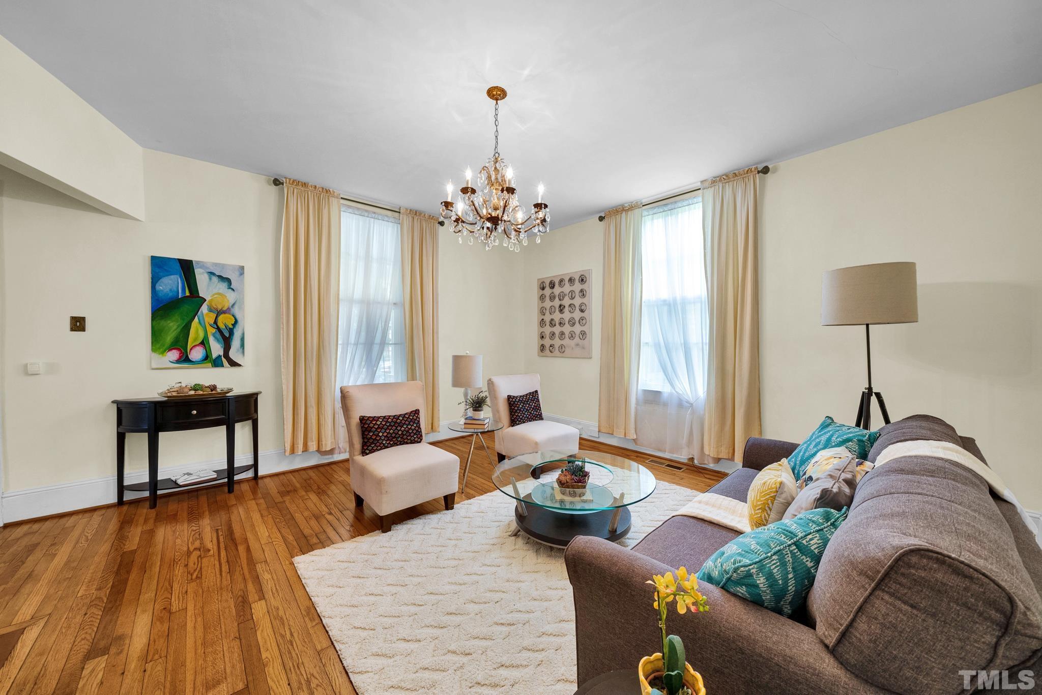 545 East Jones Street Raleigh, NC 27601 - Photo 11 of 35 a living room with furniture and a chandelier