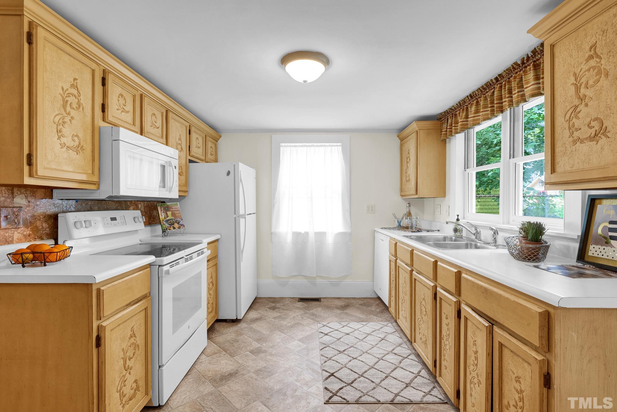 545 East Jones Street Raleigh, NC 27601 - Photo 18 of 35 a kitchen with a sink stove and cabinets