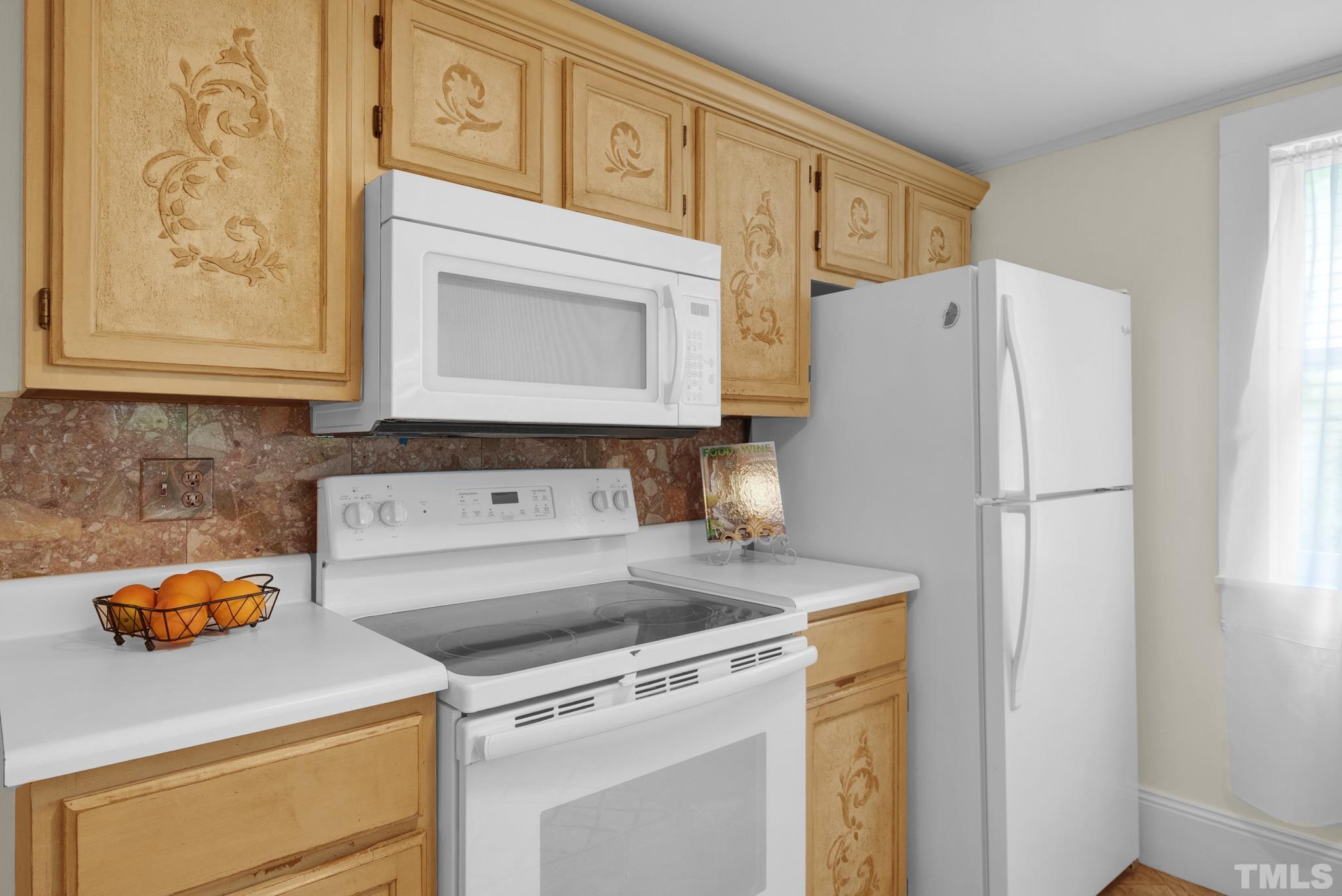 545 East Jones Street Raleigh, NC 27601 - Photo 19 of 35 a kitchen with stainless steel appliances white cabinets and a refrigerator
