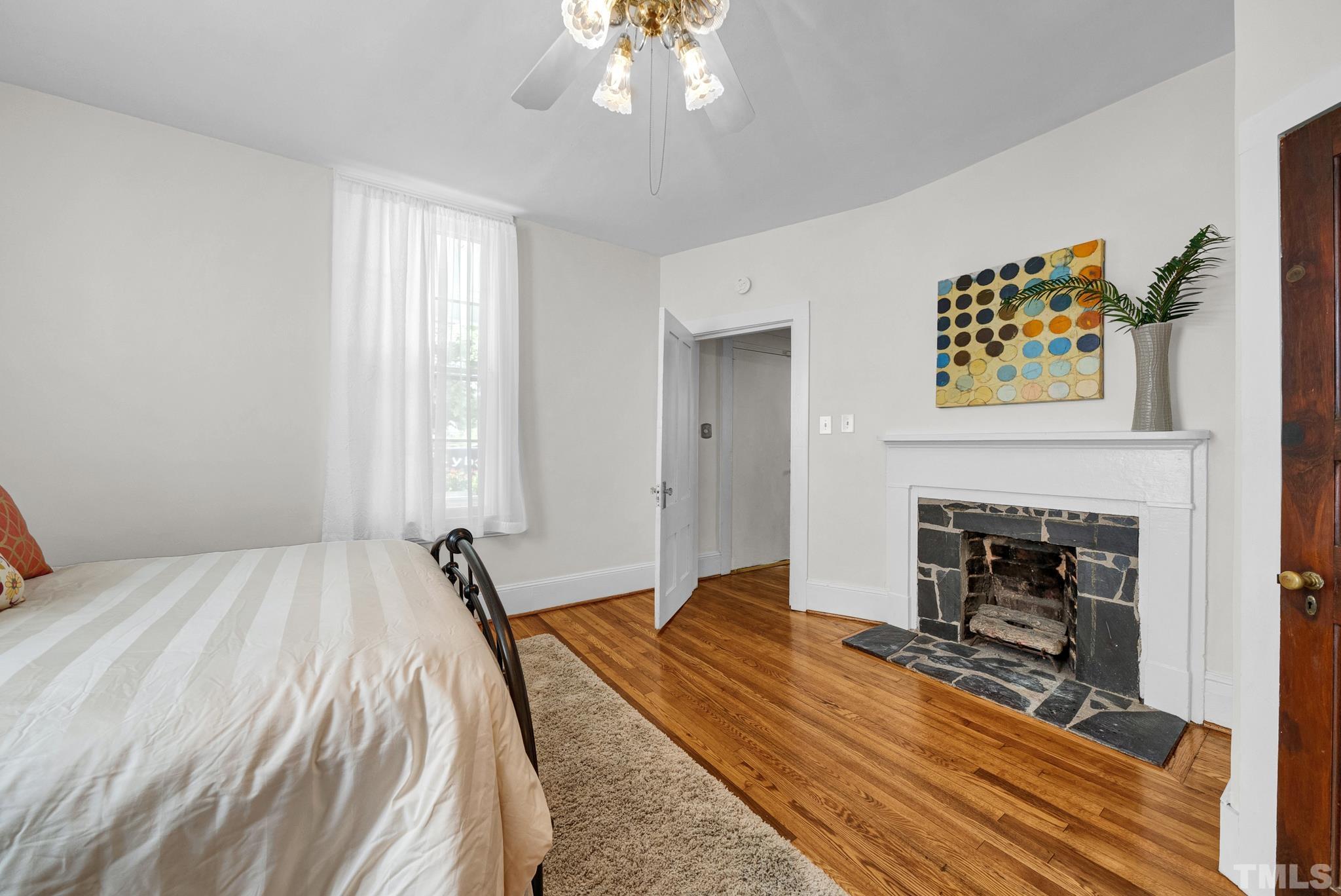 545 East Jones Street Raleigh, NC 27601 - Photo 23 of 35 a bedroom with a bed and a fireplace
