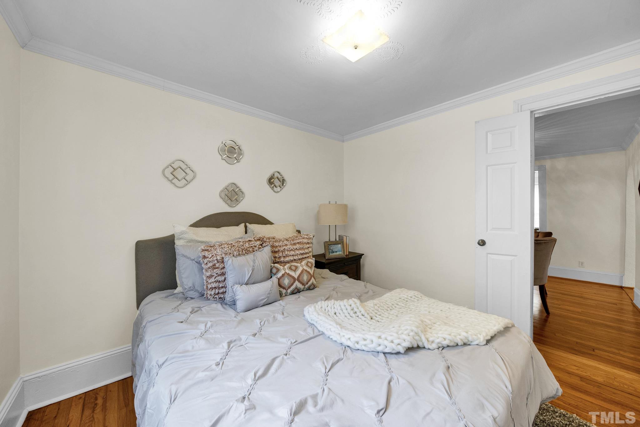 545 East Jones Street Raleigh, NC 27601 - Photo 29 of 35 a bedroom with a bed and a dresser