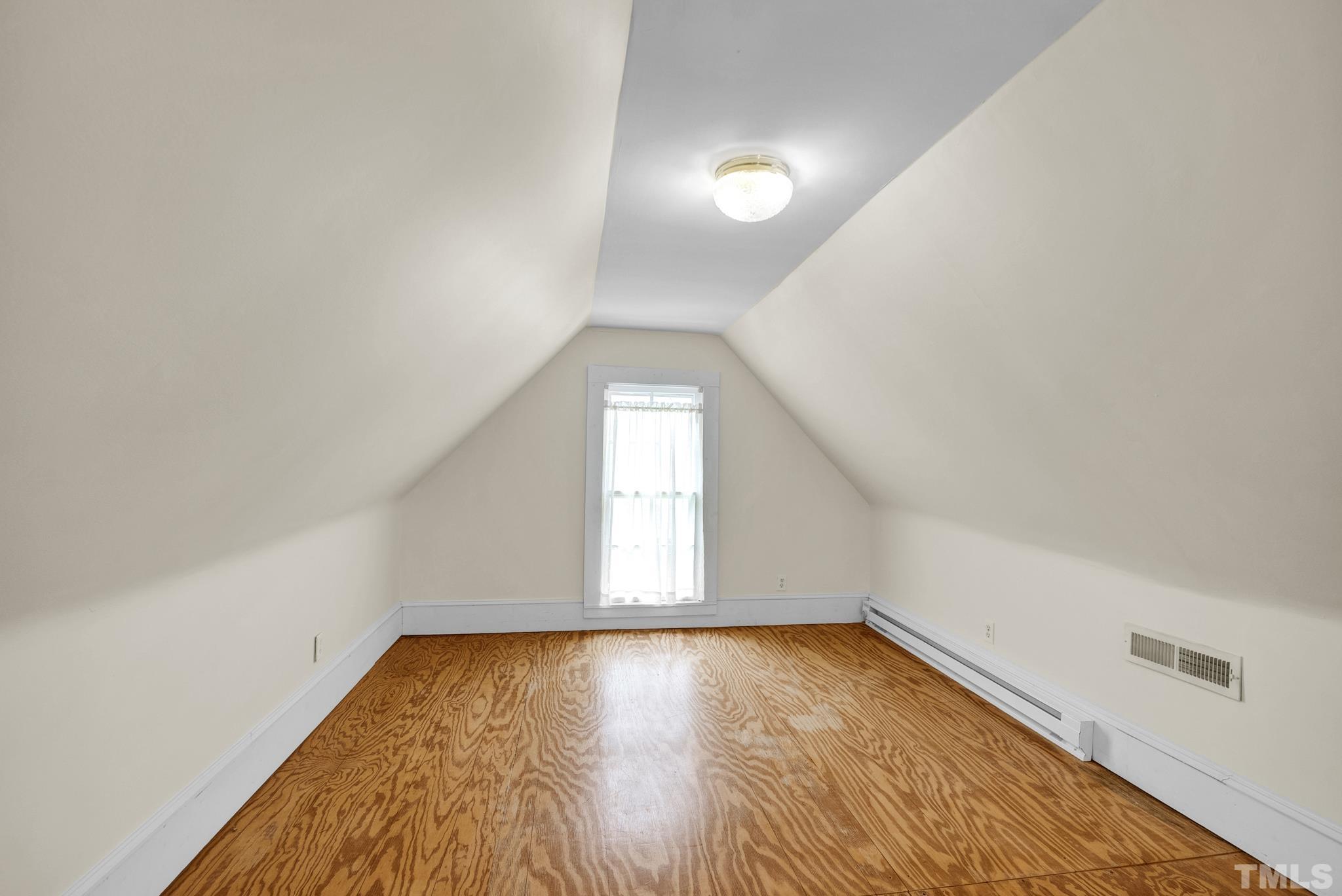 545 East Jones Street Raleigh, NC 27601 - Photo 34 of 35 an empty room with wooden floor and windows