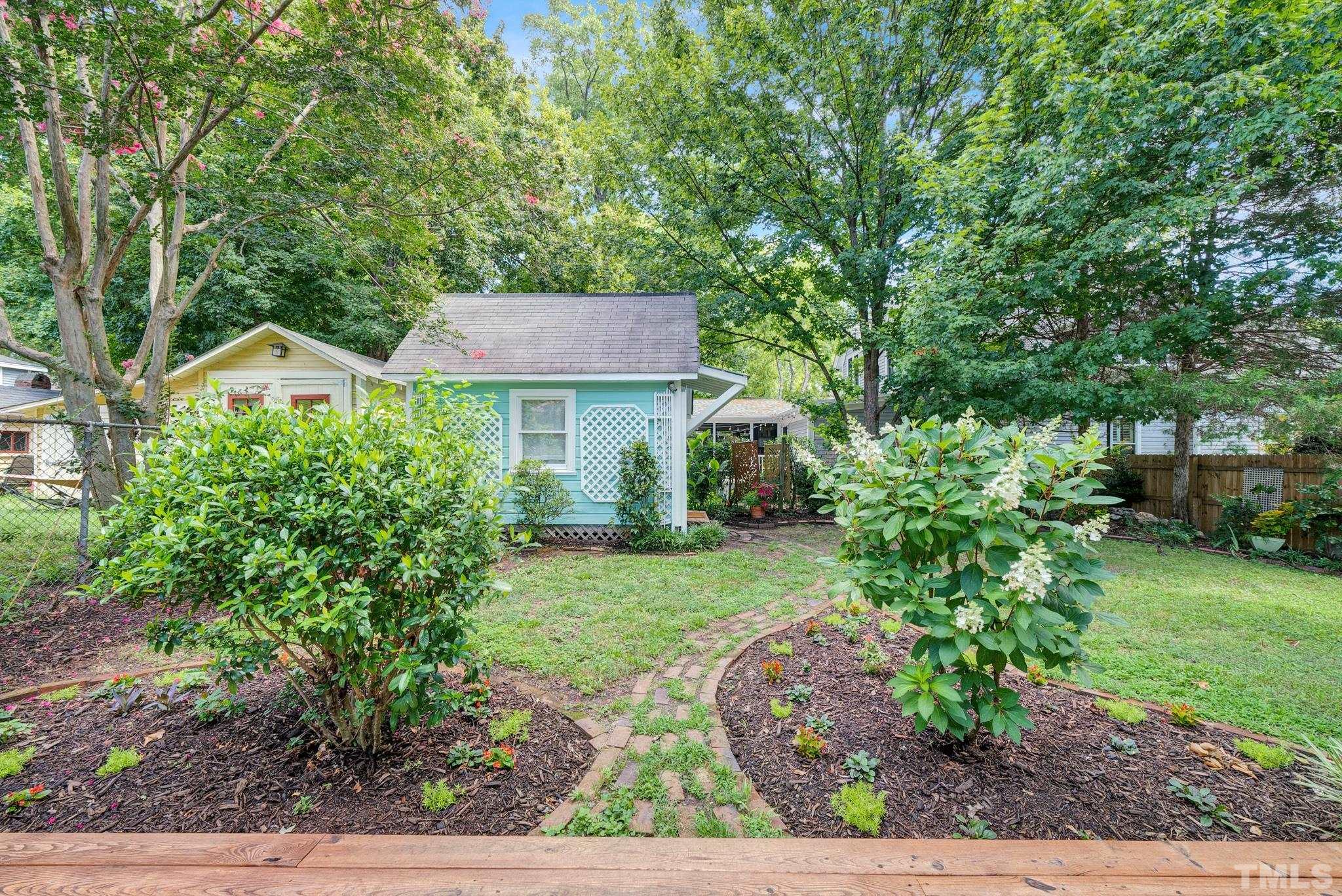 545 East Jones Street Raleigh, NC 27601 - Photo 7 of 35 a front view of a house with a yard and a garden