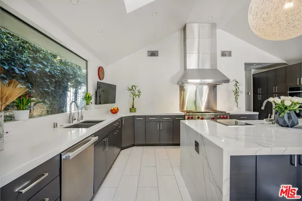 a kitchen with stainless steel appliances granite countertop a sink stove and cabinets