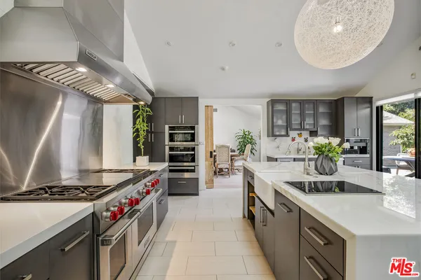 a kitchen with stainless steel appliances a sink stove and cabinets