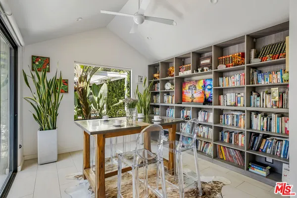 a work room with furniture and a book shelf