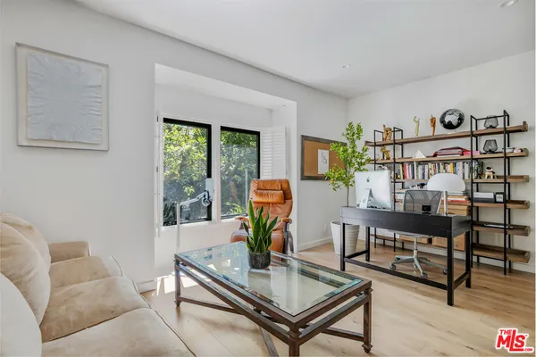 a living room with furniture and a bookshelf
