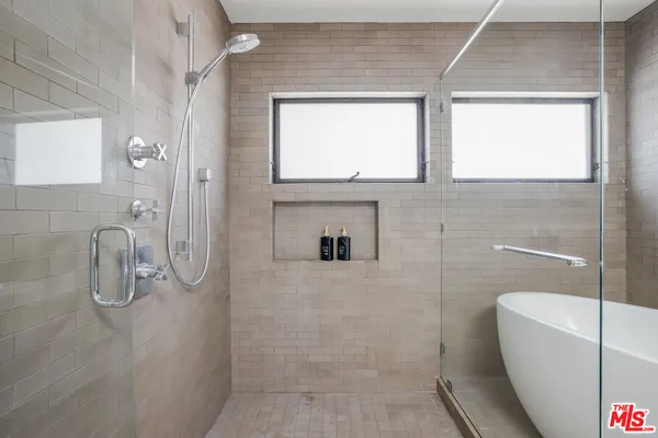 a bathroom with a granite countertop sink a toilet and shower