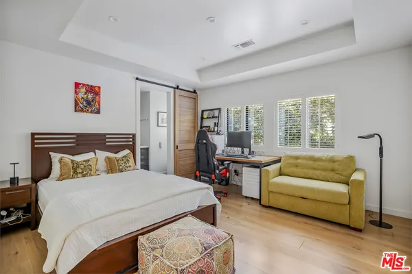 a bedroom with a bed and a couch