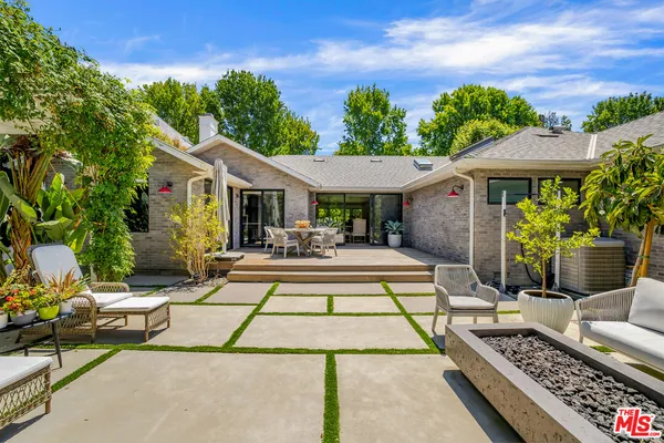 a view of a house with sitting area and swimming pool