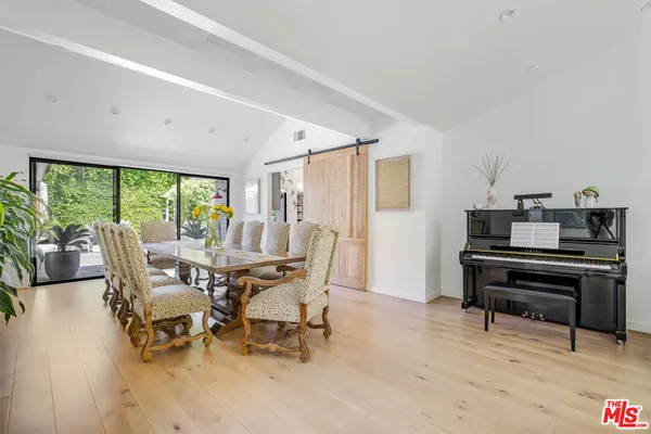 a living room with furniture and a piano