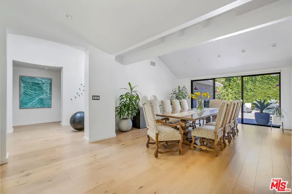 a dining room with furniture and wooden floor